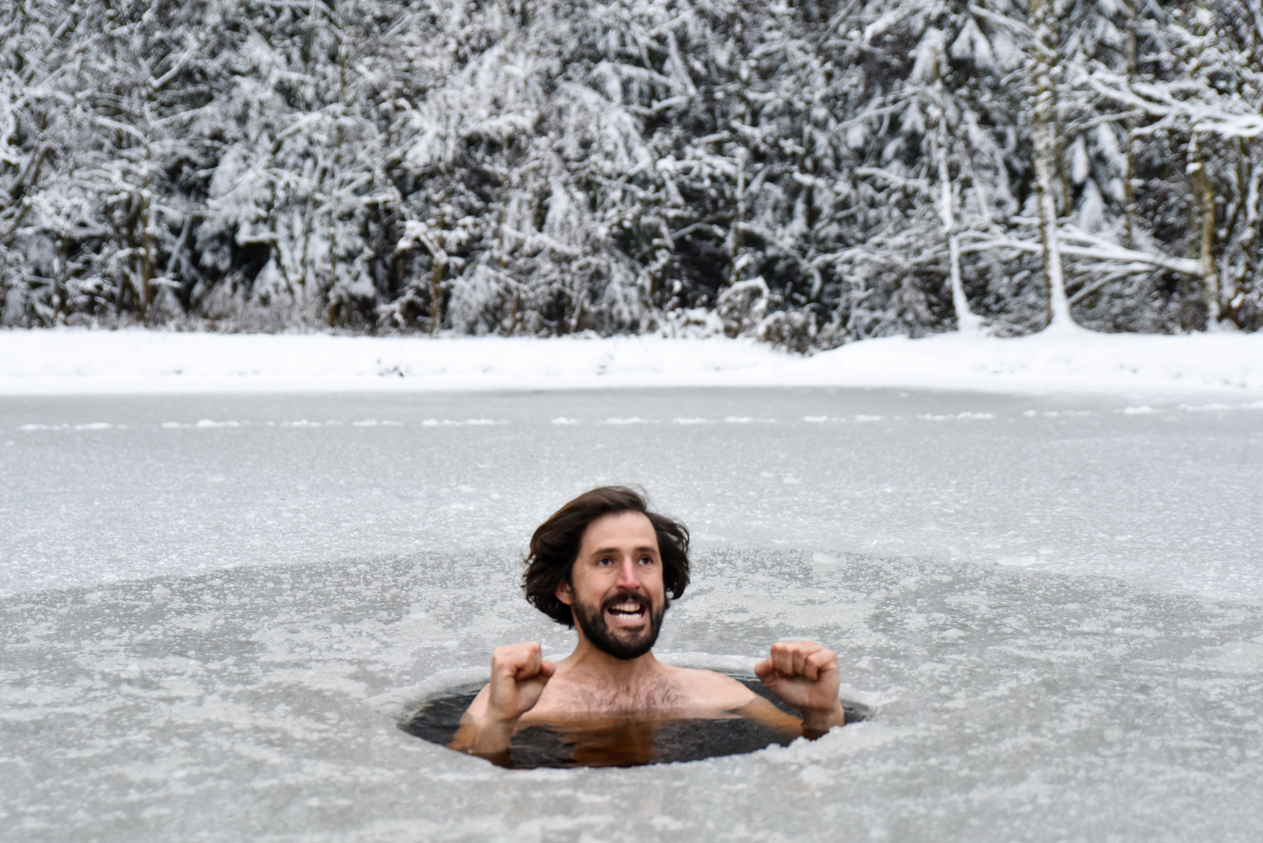 Young man have bath in cold water and does Wim hof method and gesturing